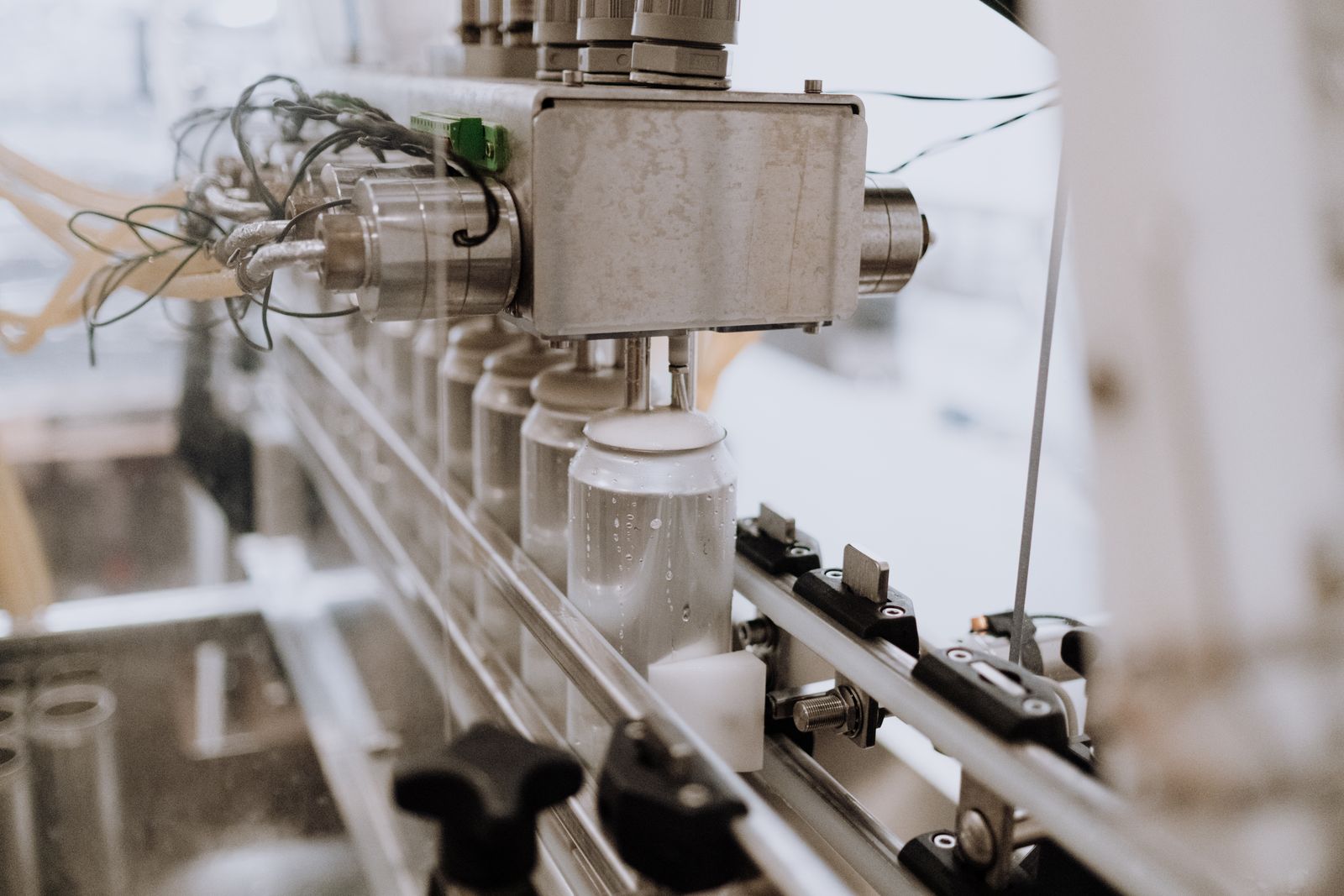 Cans being filled on a stainless steel canning line